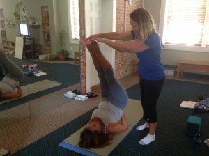 Assisting Linda with Ardha Sarvangasana (half shoulder stand)