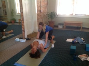 Helping Linda achieve a deeper stretch in Matsyasana (fish pose)